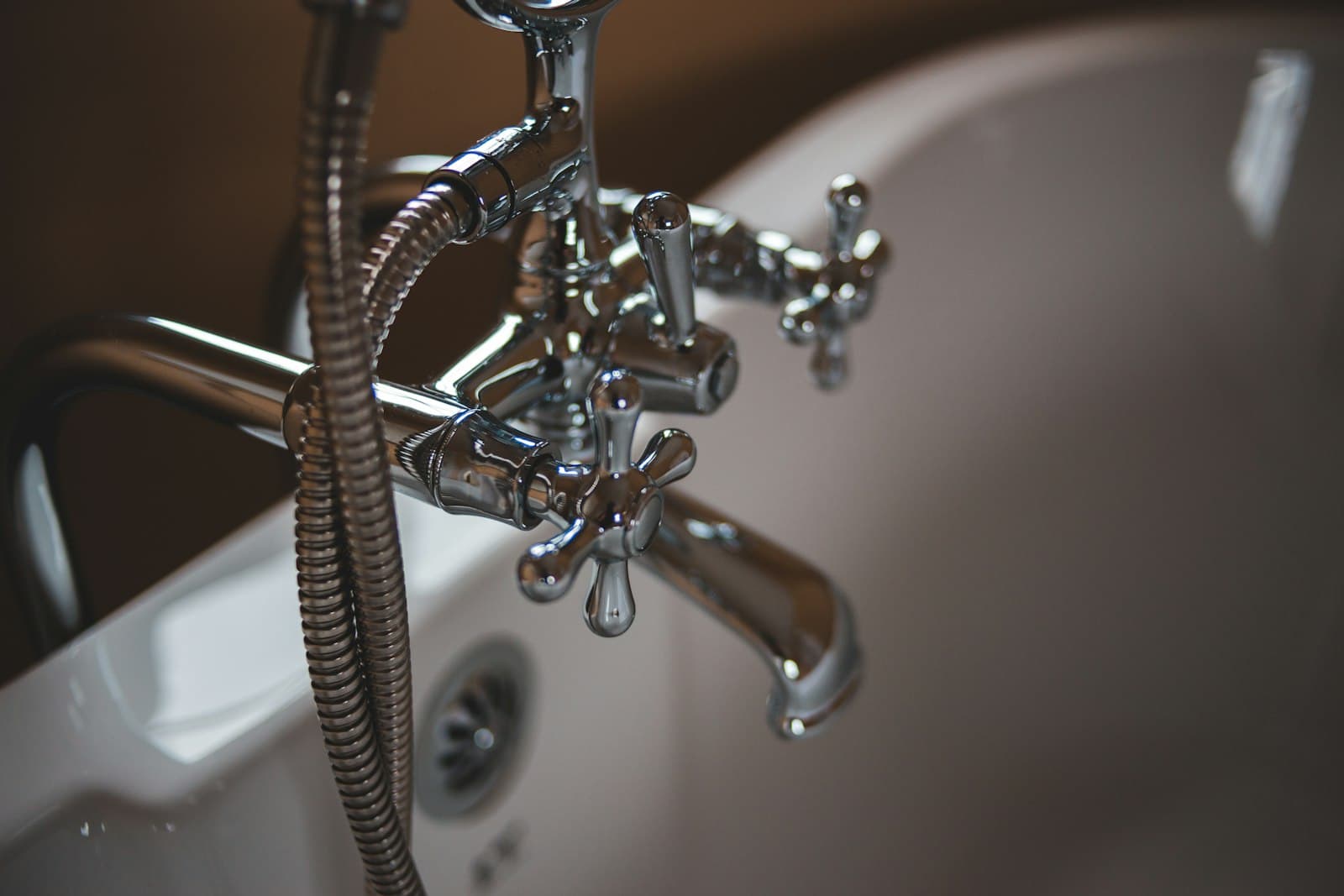 Chrome tub faucet and handheld shower