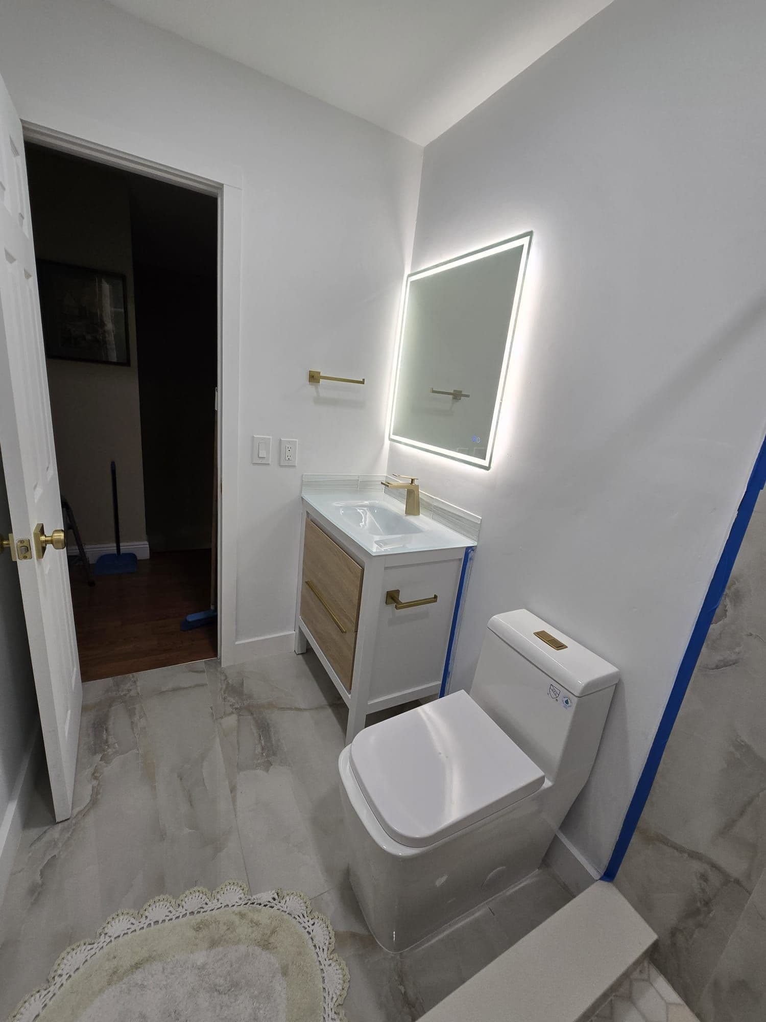 Guest bathroom remodel with gold fixtures completed by D&H Kraft